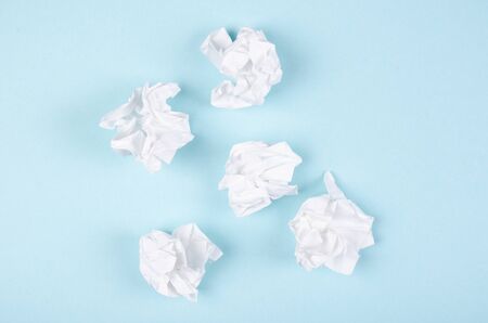 Crumpled paper composition on blue background. Flat lay, layout and tabletop mockup with copy space.の写真素材