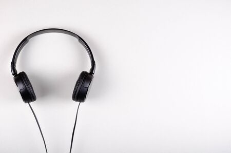 Black headphones composition on gray background. Flat lay, layout and tabletop mockup with copy space.の写真素材