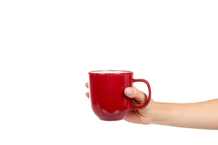 Hand with red porcelain tea cup. Ceramic coffee mug. Isolated on white background. Copy space.の写真素材