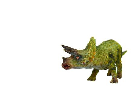 Green rubber dinosaur toy, prehistoric wild animal. Isolated on white background. Copy space.の写真素材