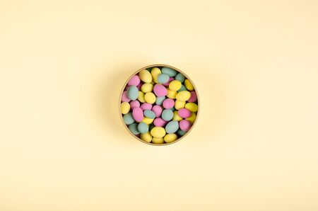 Colored candies composition on biege background, party and celebration decoration. Flat lay, layout and tabletop mockup with copy space.の写真素材