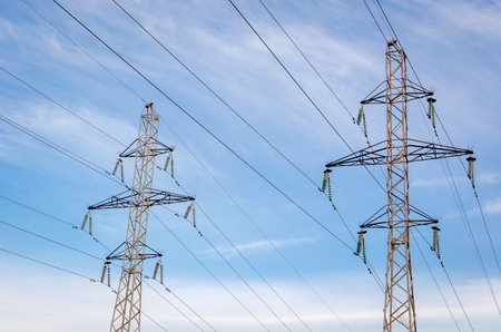 High-voltage towers against the sky. Transporting electricity for long distances. Wires.
