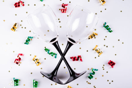 Wineglasses with confetti composition on gray background. Flat lay, layout and tabletop mockup with copy space.の写真素材