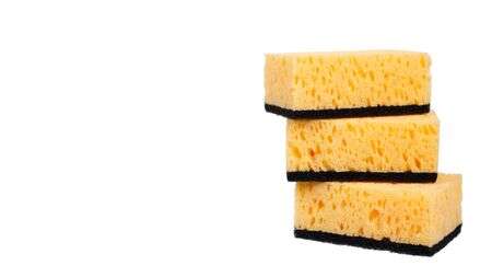 Orange kitchen sponge, dishware foam. Isolated on white background. Copy space, template.の写真素材