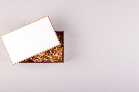 Box with hay or straw, packing template. Flat lay.