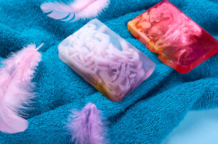 Spa concept idea,towel and soap composition on blue background. Flat lay.