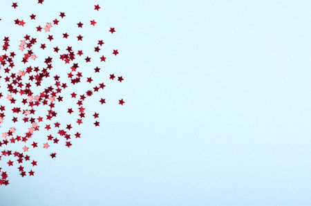 Star shape confetti scattered on background. Flat lay.