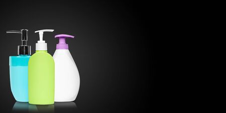 Different liquid soap bottles on dark background. Copy space, template.の写真素材