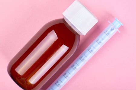 Baby antipyretic bottle on pink background. Flat lay, overhead view image.の写真素材