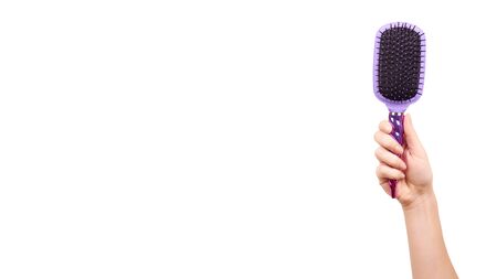 Hand with purple hairbrush, hair care and beauty. Isolated on white background. Copy space, template.の写真素材