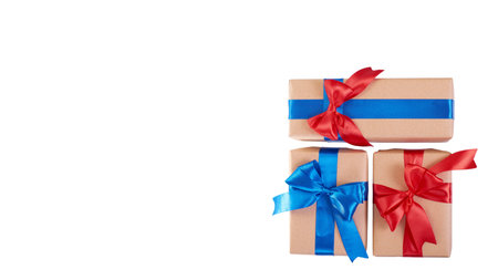 Gift box wrapped with brown paper. Isolated on white background. Copy space, template.