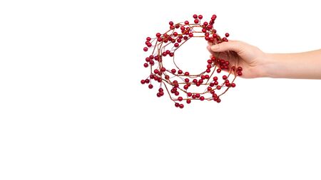 Hand with red berry wreath, holiday decoration. Isolated on white background. Copy space, template.の写真素材