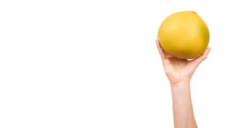 Hand with fresh and juicy pomelo fruit. Isolated on white background. Copy space, template.の写真素材