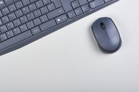 Keyboard and mouse on grey background. Flat lay, overhead view image. Copy space, template.の写真素材