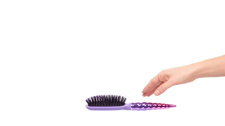 Hand with purple hairbrush, hair care and beauty. Isolated on white background. Copy space, template.の写真素材