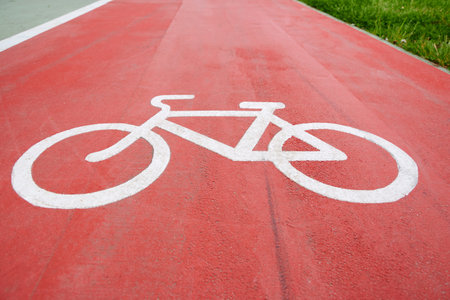 Bicycle lane sign, white sign on a red background.