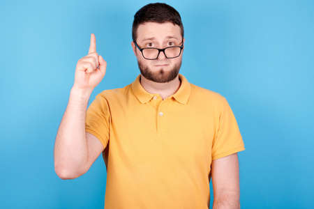 Brunette man with glasses showing thumbs up, have an idea.の写真素材