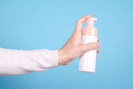 Face foam bottle in hand.の写真素材