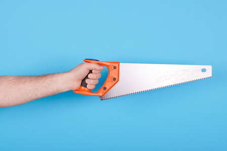 Hand with handsaw, carpentry and construction tool.の写真素材