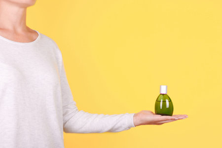 Hand with luxury perfume bottle.