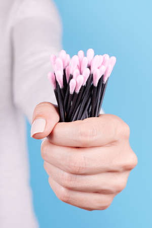 Hand with black ear stick.の写真素材