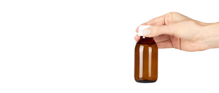 Medical glass bottle with hand, syrup. Isolated on white background.の写真素材