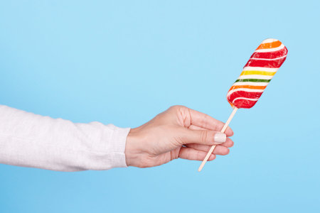 Hand with striped candy cane.