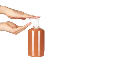 Liquid antibacterial soap in bottle with hand. Isolated on white background.