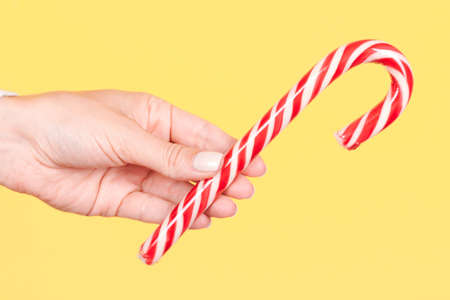 Hand with red striped candy cane.の写真素材