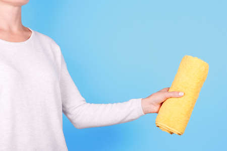 Hand with folded yellow towel.の写真素材