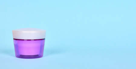 Skin care cream in purple container.の写真素材