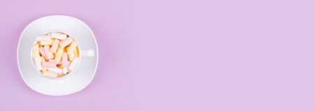 Colored marshmallow composition on purple background.の写真素材