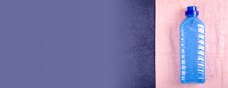 Blue conditioner in bottle on textile composition.