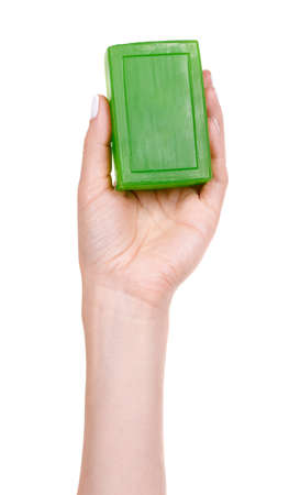 Hand with handmade green soap bar.の写真素材