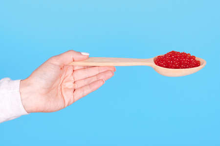 Salmon fish caviar, seafood on wooden spoon.の写真素材