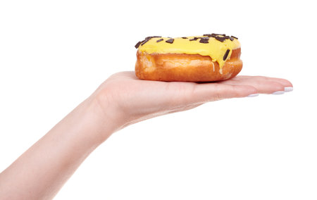 Sweet donut with icing and chocolate drops.