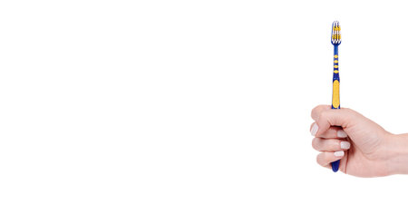 Blue and yellow plastic toothbrush, dental care.の写真素材