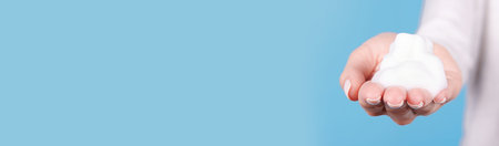 Hand with white bubble foam.の写真素材