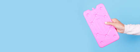 Hand with pink ice cooler, portable refrigeran.の写真素材