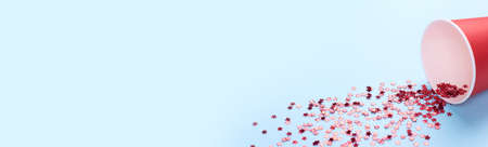 Star shape confetti scattered on background from cup.の写真素材