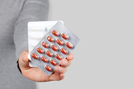 Hand with pills in blister.