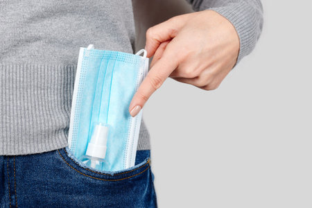 Medicine protective mask in jeans pocket.