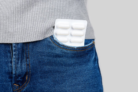 Medical pills in jeans pocket.