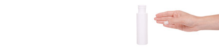 The hand with the white bottle with the disinfectant is isolated on a white background. High quality...