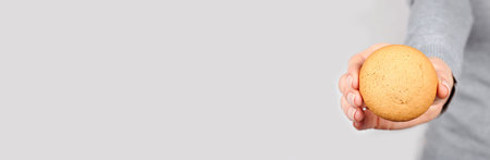 Hand with homemade cookies on grey.の写真素材