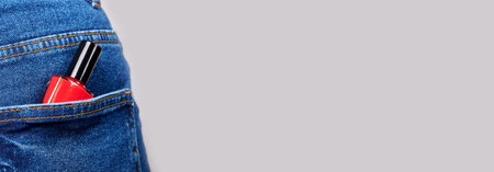 Red nail polish in jeans pocket.の写真素材