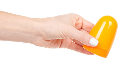 Hand with yellow bottle with slime isolated on white