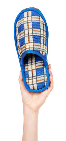 Hand with home textile slippers isolated on whiteの写真素材