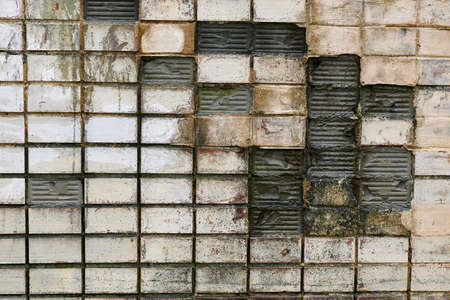 Old cracked ceramic tiles, broken wall.の写真素材