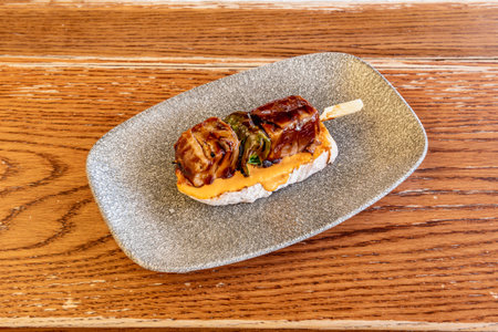 delicious skewer of red tuna and pak choi on a slice of bread with teriyaki sauce